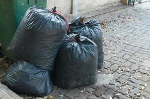 Several black bag of garbage photo