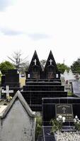 Public cemetery with varied graves. photo