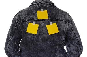 The blank yellow notes on sticky tape of the man back side with empty space for text. April fools day prank concept. photo