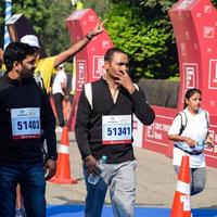 New Delhi, India - October 16 2022 - Vedanta Delhi Half Marathon race after covid in which marathon participants about to cross the finish line, Delhi Half Marathon 2022 photo