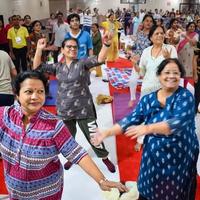 Delhi, India, June 19 2022 -Group Yoga Aerobics session for people of different age groups in Balaji Temple, Vivek Vihar, International Yoga Day, Big group of adults attending aerobics class in temple photo