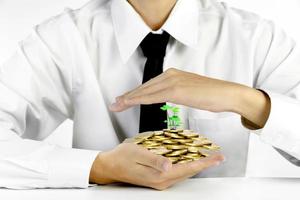 businessman hands protecting piles of golden coins,Lucky economic growth concept photo