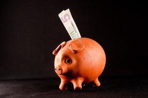 Piggybank on black background photo