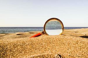 Magnifying glass at the beach photo