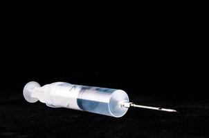 Syringe on black background photo