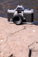 Old camera on a rock photo