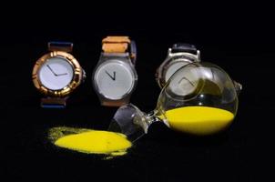 Watches and broken hourglass photo