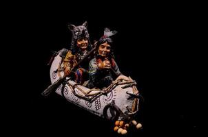 Small Native American figures in a boat photo