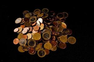 Coins on black background photo