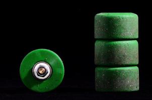 Skateboard wheels on black background photo