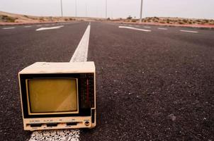 Old television on the road photo