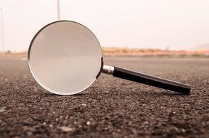 Magnifying glass on the road photo