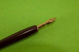 Fountain pen on green background photo