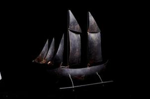 Sailing ship model on black background photo