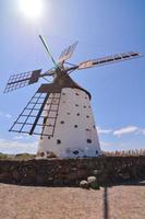 Traditional windmill under blue sky photo