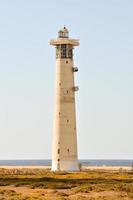 Lighthouse by the sea photo