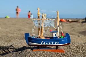 barco de juguete en la playa foto