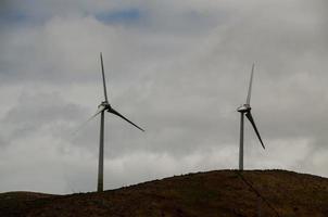 Wind power generators on a hill photo