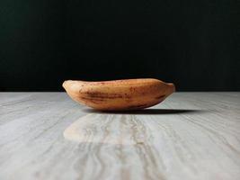 Isolated banana front of floor with dark background photo