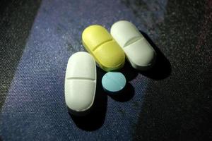 Colorful drugs. Pills and capsules on a dark background. photo