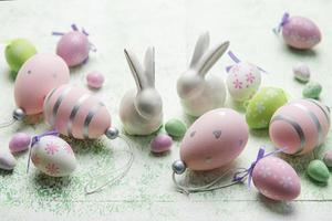 Decorative rabbits and  Easter eggs on the table photo