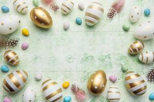 Decorative colored Easter eggs on a green wooden background photo