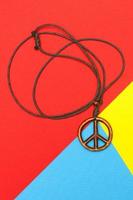 Peace symbol pendant on red yellow and blue colors photo