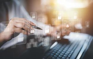 Hand using laptop and touch folder of document Management System, online documentation database and process automation to efficiently manage files work, knowledge, Corporate business technology, photo