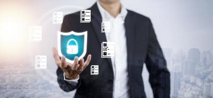 Businessman hand hold spam security icon folder of document Management System,  online documentation database and process automation to efficiently manage files work, Corporate business technology. photo