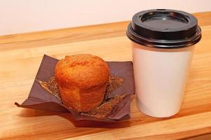 Coffee and muffin on the table photo