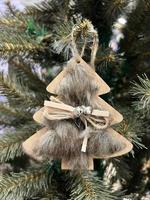 Zero waste. Eco Christmas tree decor toy - wooden pendant is decorated with fur, ribbon and bell, without plastic. Perfect content for advertising banner, gift card or creative projects.