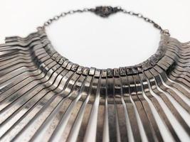 a circular svana necklace on a plain background photo