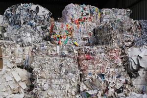 Wastepaper compact texture pile for recycling on sorting plant. Technology of reuse materials. Stack of shredded paper. Save the planet ecology concept. Industry of reduced pollution factory. Close-up photo