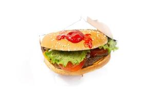 hamburguesa con salsa de tomate sobre un fondo blanco. foto