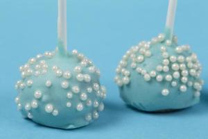 Candies on sticks. Blue cakes on a blue background.Beautiful sweet dessert photo