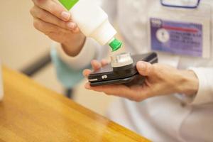 A dermatologist doctor treats with a solution of a modern device using light, a phone application and a camera to examine birthmarks and moles. photo