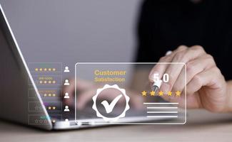 Man touch smartphone with Customer review satisfaction feedback survey concept, User give rating to service experience on online application, service leading to reputation ranking of business. photo
