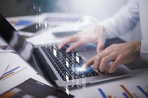 Businessman working on laptop with virtual screen. Online documentation database, IT consultant being set up Virtual Document Management System with laptop,Software for archiving corporate files. photo