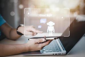 Man using Laptop and touch bar Chat bot Chat with AI, Artificial Intelligence,System Artificial intelligence an artificial intelligence chatbot, Digital chatbot, Robot application, conversation photo