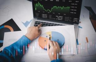 Man using laptop with planning and strategy, Stock market, Business growth down, Concept of financial crisis, echnical price graph and indicator, red candlestick chart with analyzing forex trading. photo