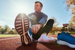 Runner get ready for run, tying sneakers shoelaces photo