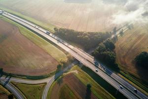Car traffic on highway at summer day, aerial view photo