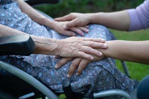 Holding hands Asian senior or elderly old lady woman patient with love, care, encourage and empathy at nursing hospital ward, healthy strong medical concept photo