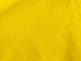 Yellow velvet fabric texture used as background. Empty yellow fabric background of soft and smooth textile material. There is space for text. photo