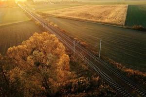 Aerial view of railway countryside landscape at sunset photo