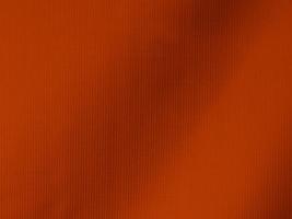 orange velvet fabric texture used as background. Tone color orange cloth background of soft and smooth textile material. There is space for text and for all types of design work. photo