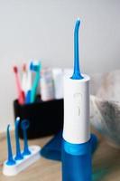 Portable oral irrigator kit in bathroom, waterpik for family use photo