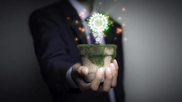 Businessman holding a light bulb, Creative new idea. Innovation, brainstorming, solution and inspiration concepts. imagination, creative thinking problem solving. photo