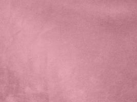 textura de tela de terciopelo color oro rosa utilizada como fondo. fondo de tela de oro rosa vacío de material textil suave y liso. hay espacio para el texto. foto
