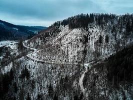 Landscape with winding road through mountain, aerial view photo